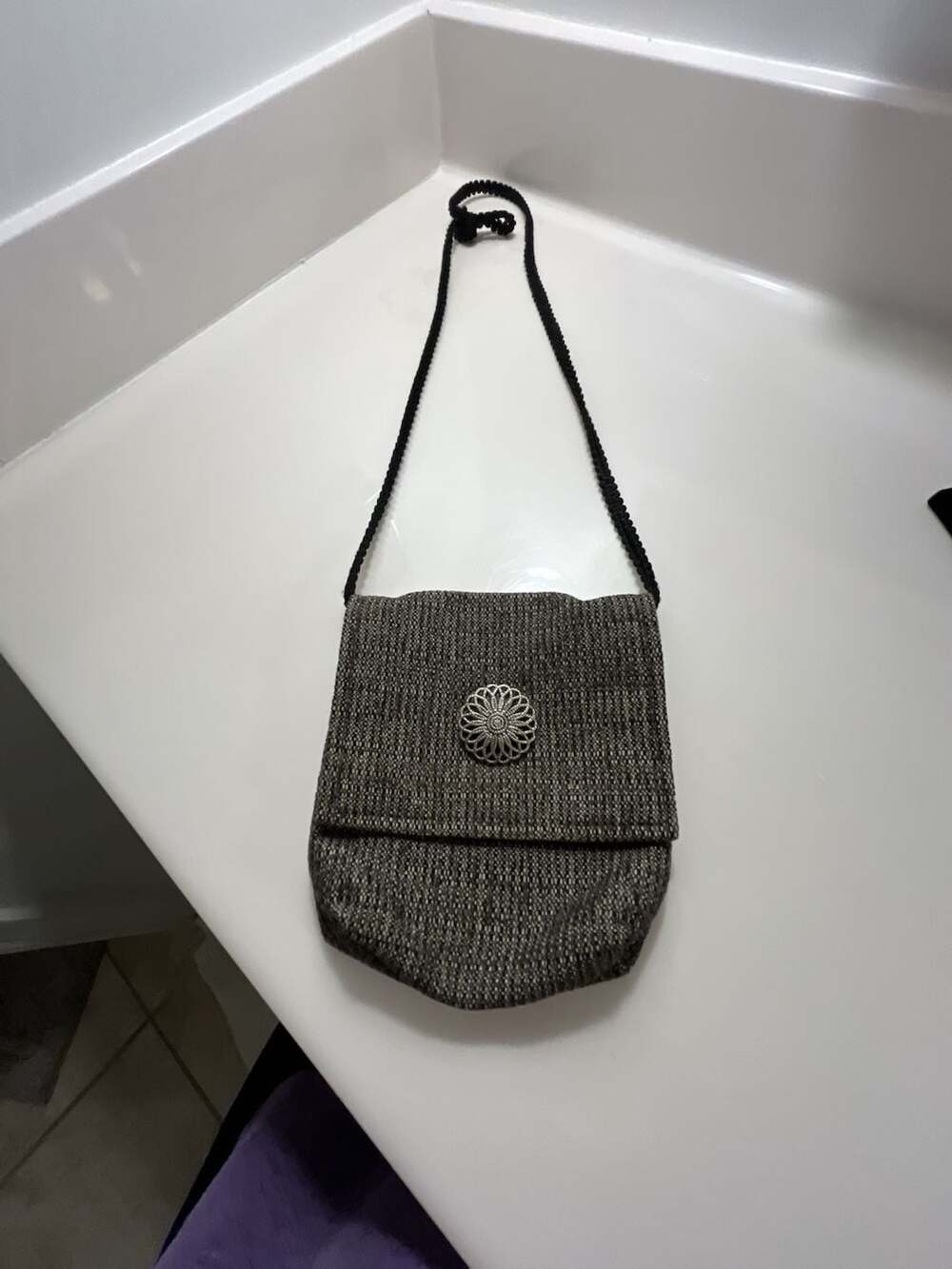 Textured Woven Crossbody Travel Bag with Decorative Metal Medallion